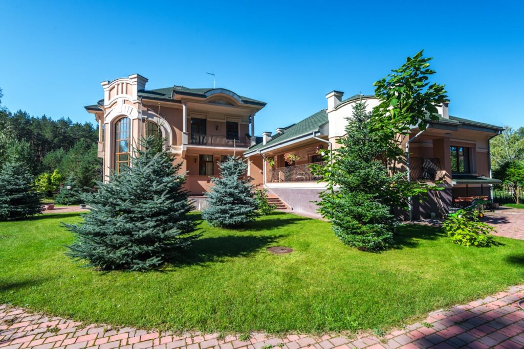 pexels-photo-8082319 Elegant suburban estate with modern architecture amidst lush greenery, captured on a sunny day.